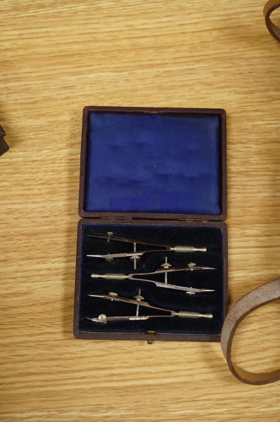 Four scientific instruments, consisting; a set of apothecaries steel balance scales, by Charles de Grave, 59, St. Martin’s le Grand…London; a set of three small drawing compasses, leather cased; a prismatic compass, by S